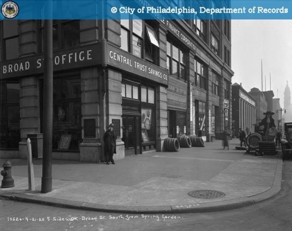 Southeast corner of Broad and Spring Garden in 1926 with Central Trust Savings Company, Lee Tires, and Automobile Finance Corporation signs