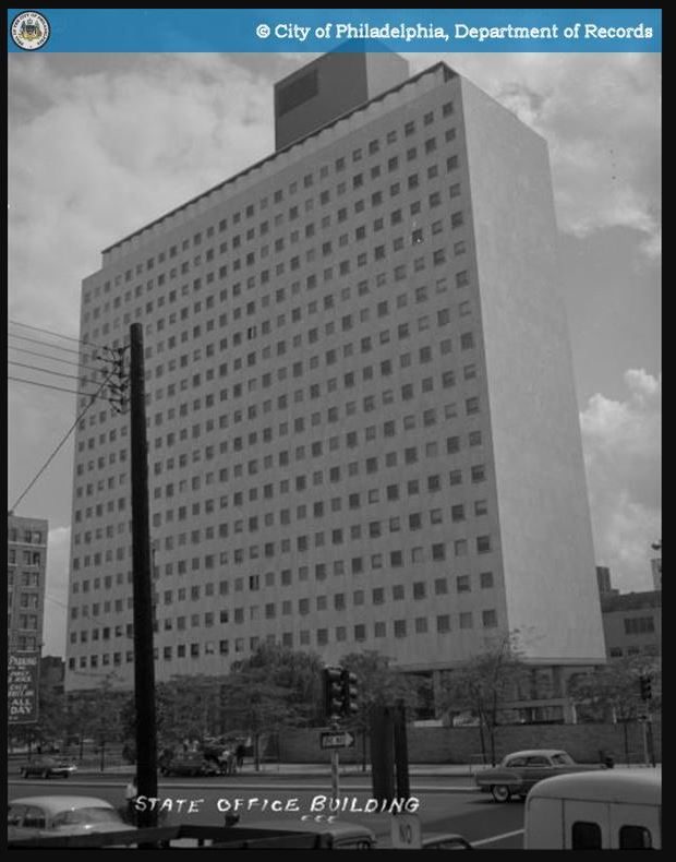 Philadelphia State Office Building at Broad and Spring Garden Streets with mid-century cars and a traffic signal