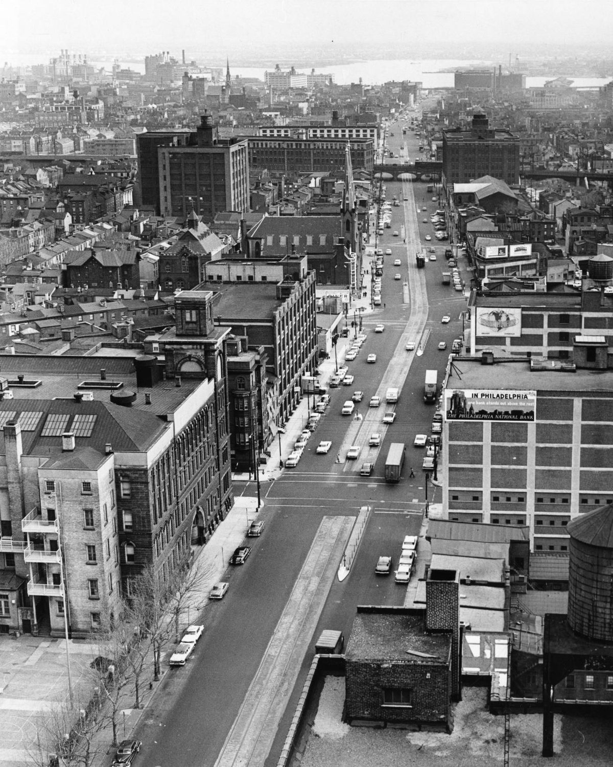 View east along Spring Garden Street at noon in 1963 from the State Office Building, toward the Delaware River, with light traffic and trolley tracks